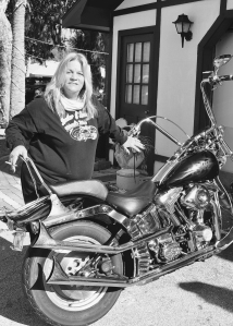 From Ch. 3 "Sisters of Steel." Leather & Lace MC Founder and president Jennifer Chaffin takes a break from overseeing her club's weeklong gathering to show her bike.