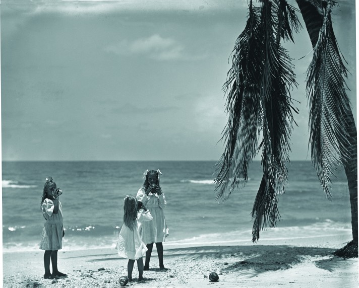 The three Olds daughters drinking from coconuts on the Marco beach. June 6, 1907; 49490. Courtesy of American Museum of Natural History